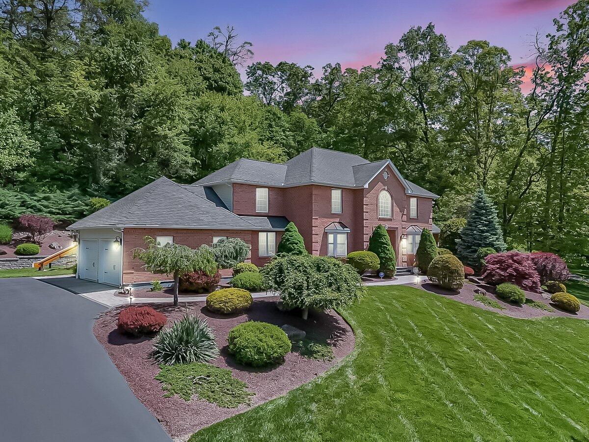 1376 Buck Ridge Drive Stroudsburg, PA 18360 - Photo 4 of 56 a front view of a house with garden