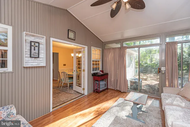 a spacious bedroom with a large window and a balcony