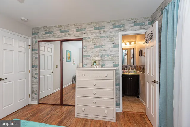 a view of a walk in closet and wooden floor