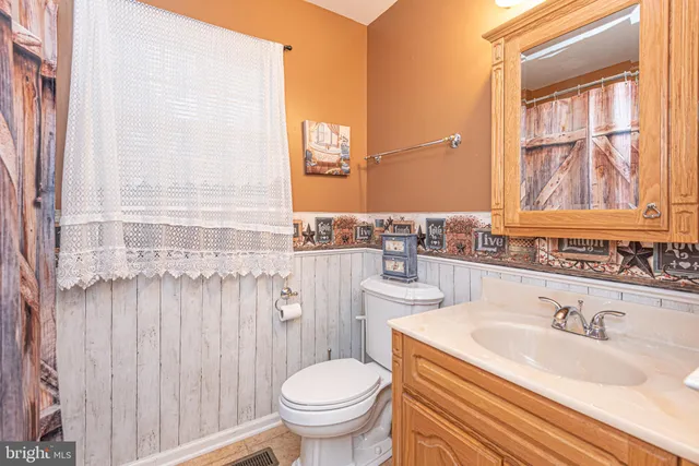 a bathroom with a sink toilet a mirror and shower