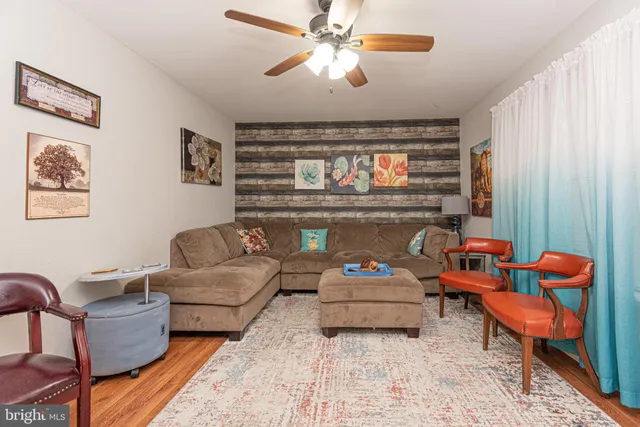 a living room with furniture a rug and a chandelier