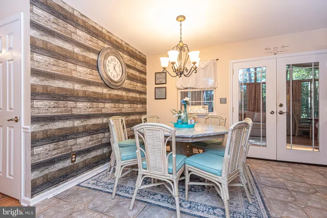 a view of a dining room with furniture and chandelier