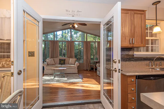 a living room with hardwood floor and a large window