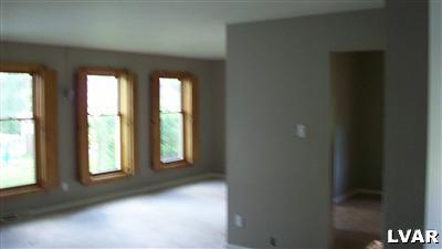 3654 Winchester Road Allentown, PA 18104 - Photo 8 of 18 The open living room is set off from a formal dining area top the right, with (2) doors to l/r and passage to kitchen. Windows flanked by built-in wood interior shutters.