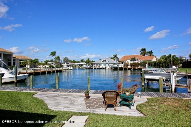 a view of a lake with lawn chairs