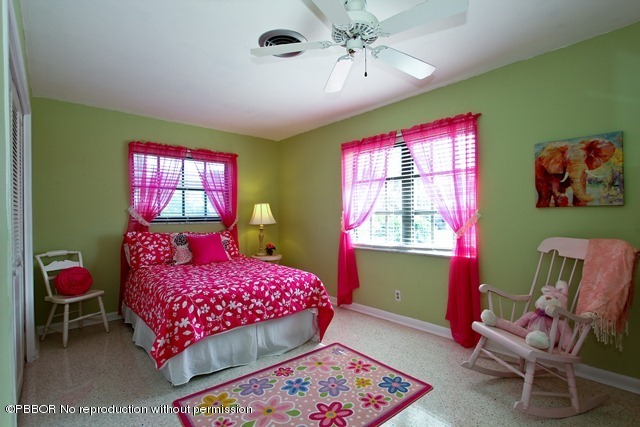 1180 Singer Drive Riviera Beach, FL 33404 - Photo 11 of 16 a bedroom with a bed and a window