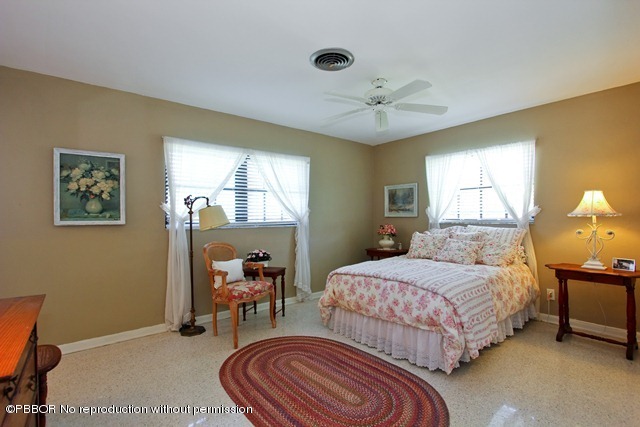1180 Singer Drive Riviera Beach, FL 33404 - Photo 12 of 16 a bedroom with a bed and wooden floor