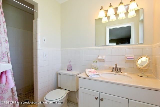 1180 Singer Drive Riviera Beach, FL 33404 - Photo 14 of 16 a bathroom with a sink mirror and toilet