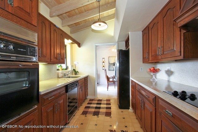1180 Singer Drive Riviera Beach, FL 33404 - Photo 5 of 16 a kitchen with a sink stove and refrigerator