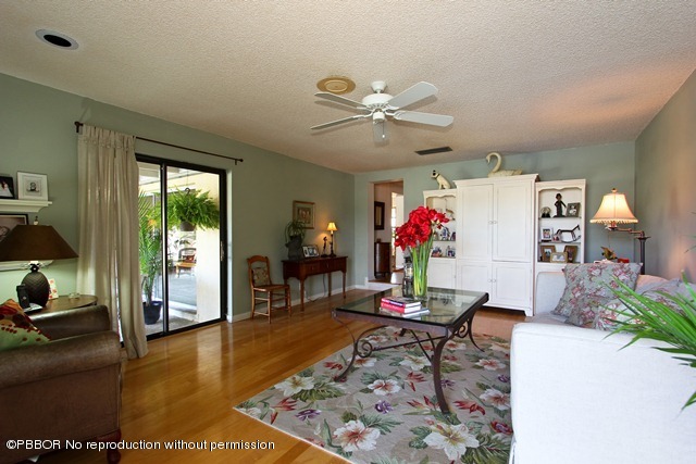 1180 Singer Drive Riviera Beach, FL 33404 - Photo 7 of 16 a living room with furniture and a flat screen tv