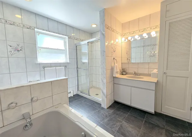 a bathroom with a double vanity sink mirror and shower