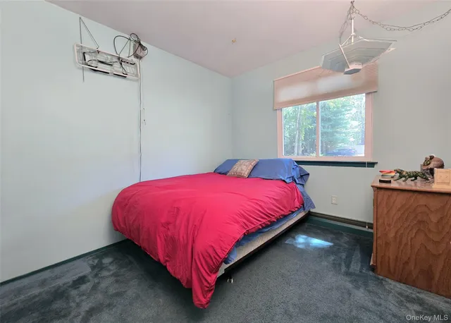 a bed sitting in a bedroom next to a window