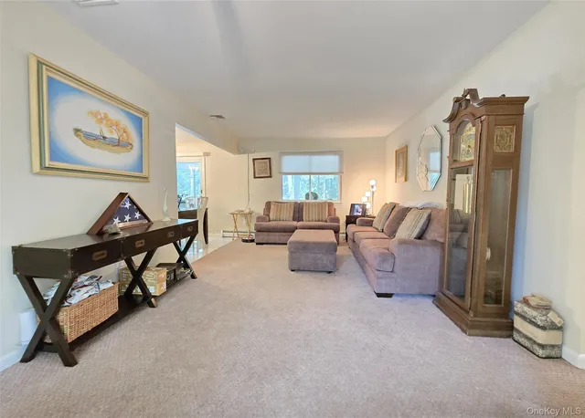 a living room with furniture and a gym machine