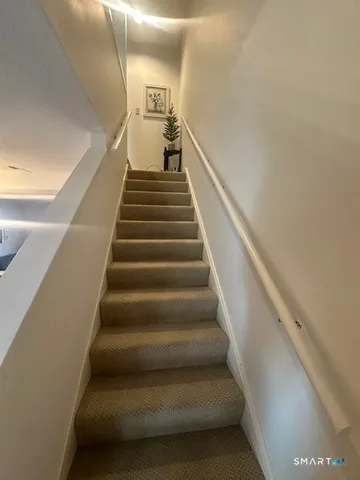 a view of a door and a car parked in front of house