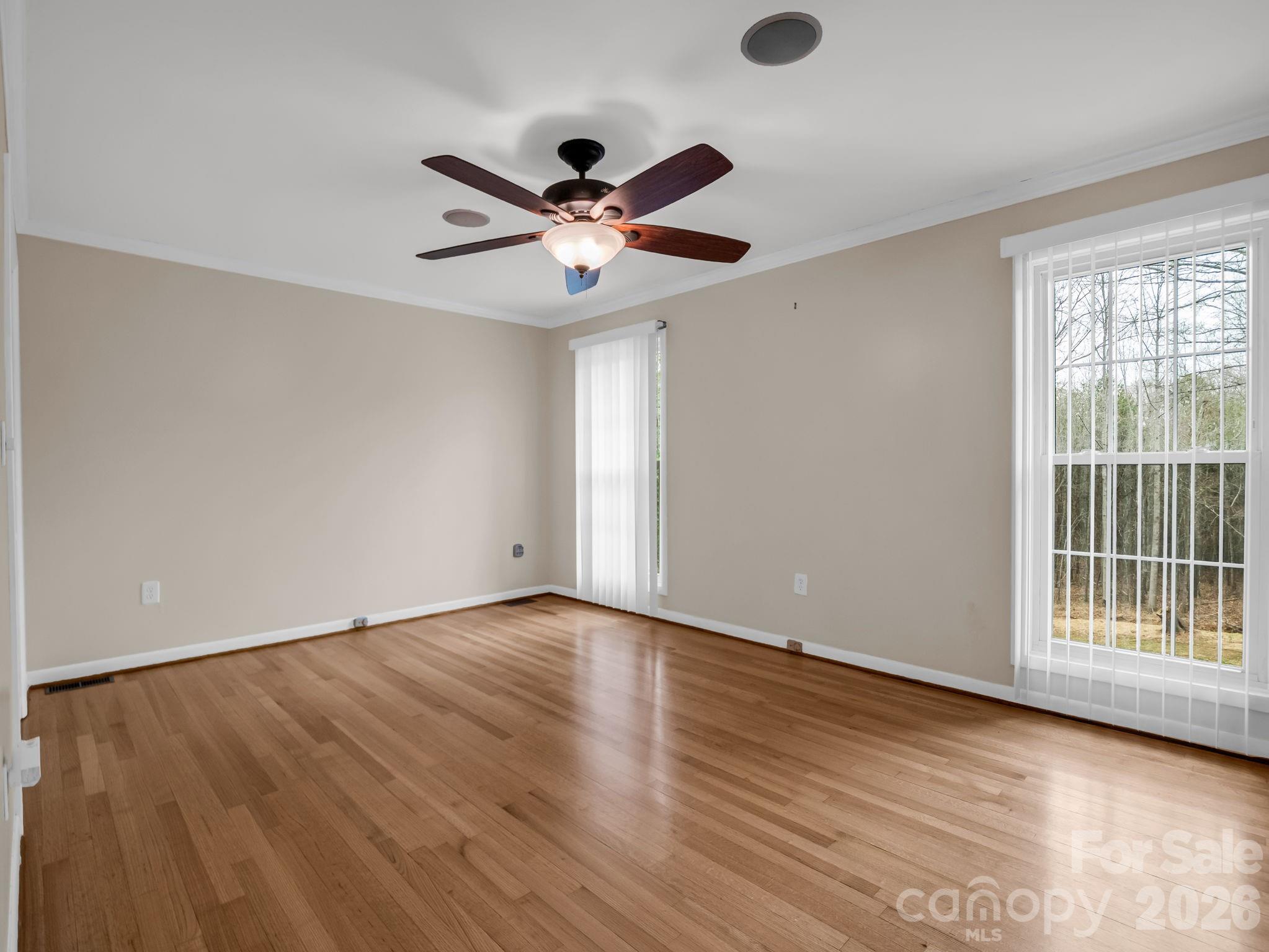 315 Walker Store Road Ellenboro, NC 28040 - Photo 16 of 39 an empty room with wooden floor and windows