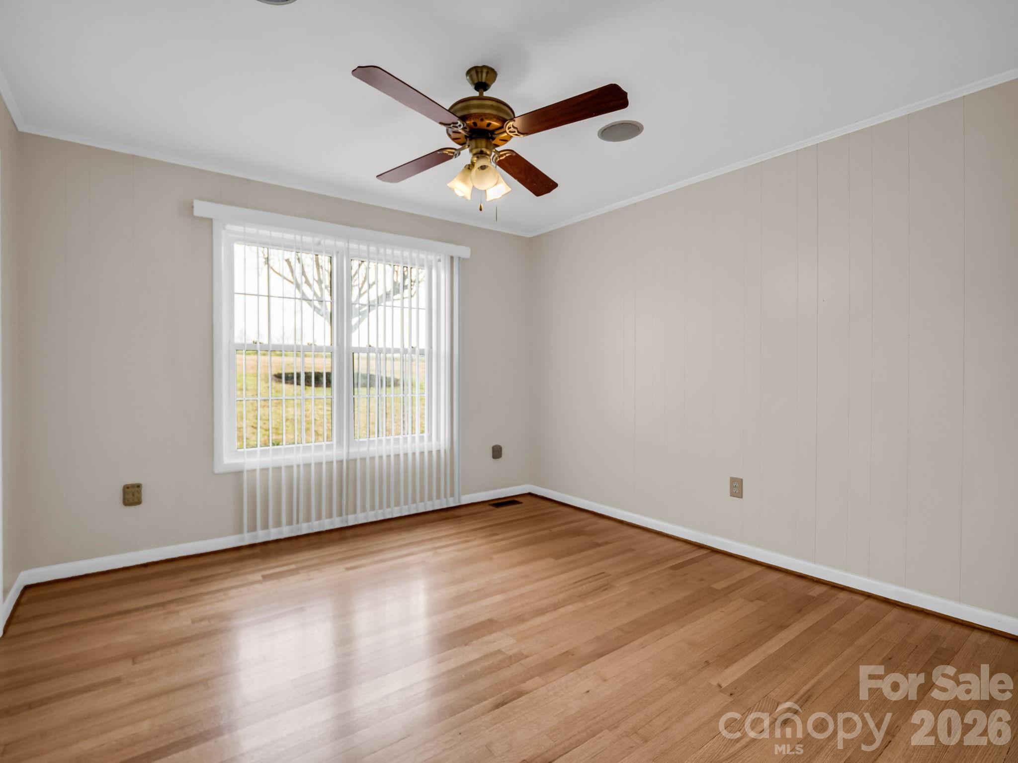315 Walker Store Road Ellenboro, NC 28040 - Photo 19 of 39 an empty room with wooden floor and windows