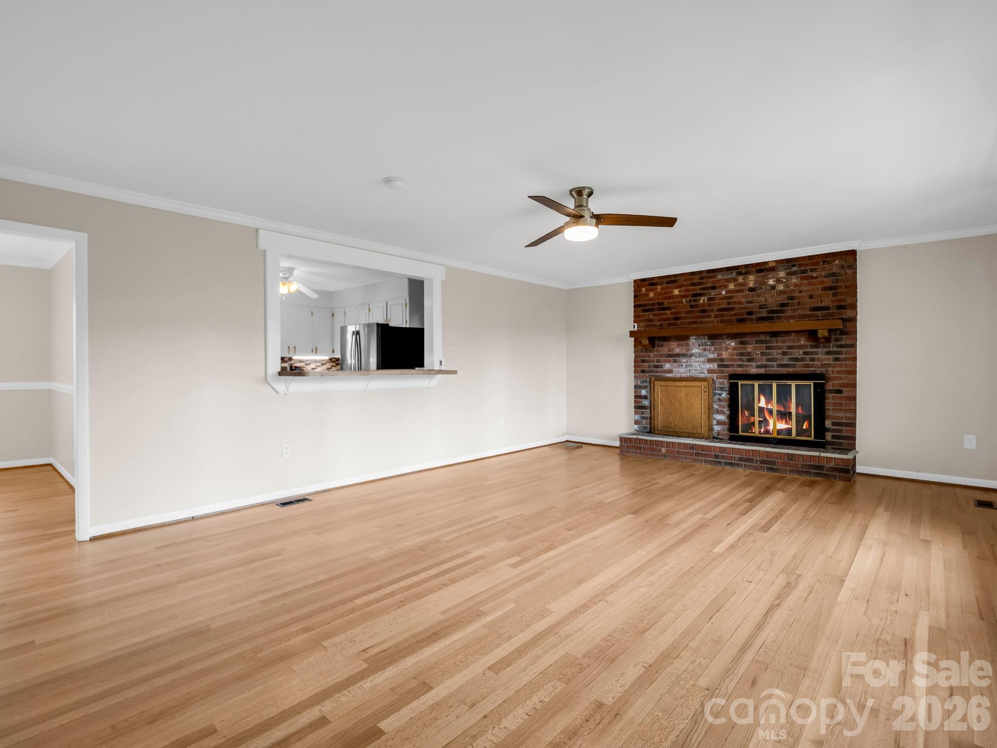 315 Walker Store Road Ellenboro, NC 28040 - Photo 7 of 39 an empty room with wooden floor and windows