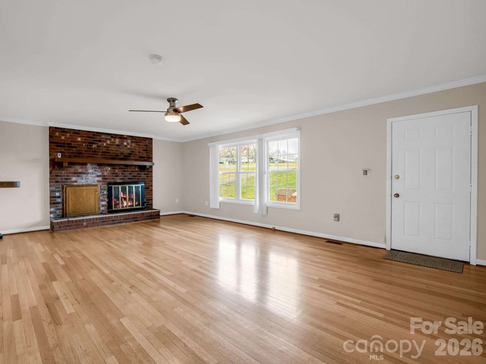 315 Walker Store Road Ellenboro, NC 28040 - Photo 8 of 39 an empty room with wooden floor and a window