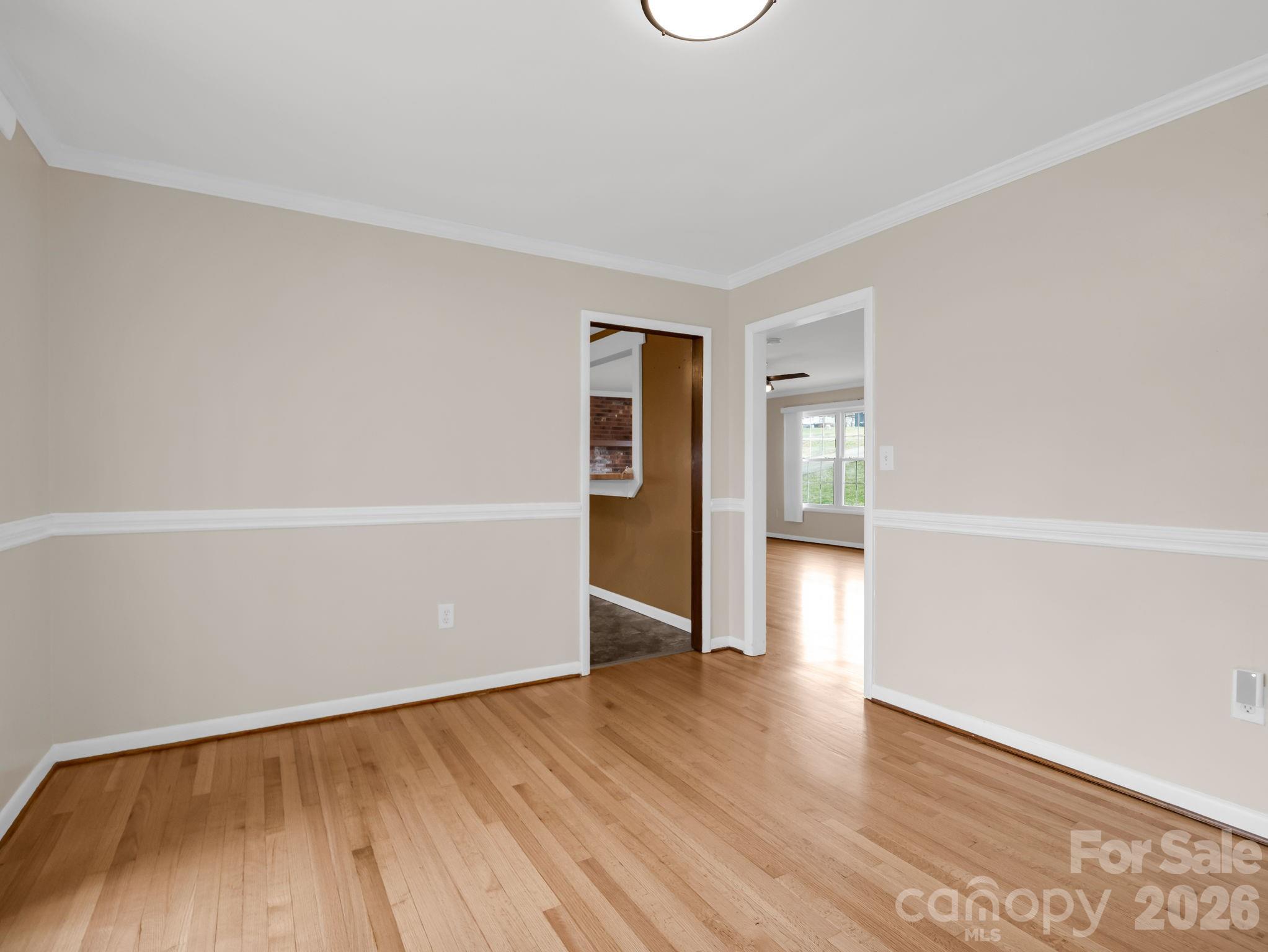 315 Walker Store Road Ellenboro, NC 28040 - Photo 10 of 39 an empty room with wooden floor and windows