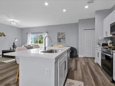 a kitchen with a sink a stove and refrigerator
