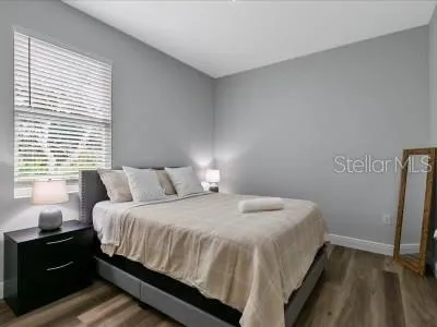 a bedroom with a bed and a window