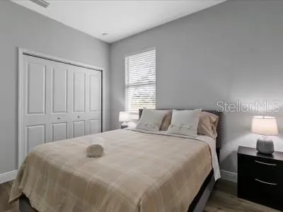 a large bed sitting in a bedroom next to a lamp