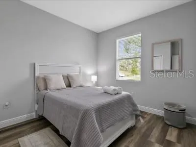 a bedroom with a bed and a window