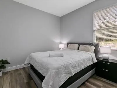 a bedroom with a bed and window