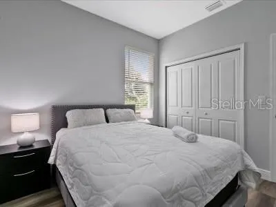 a bedroom with a bed and a lamp