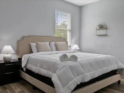 a bedroom with a bed and lamps