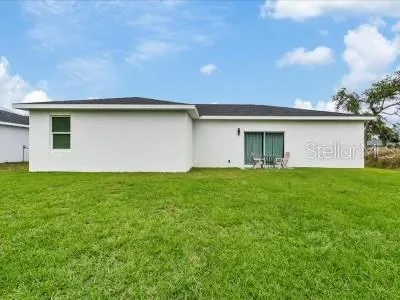 a backyard of a house with lots of green space and garden view