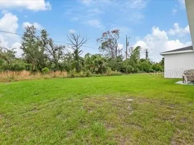 a backyard of a house with lots of green space