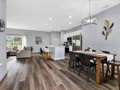 a living room with dining room and wooden floor