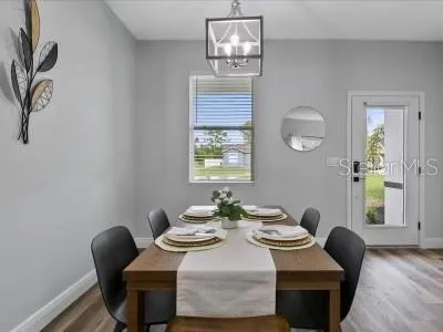 a dining room with furniture and window