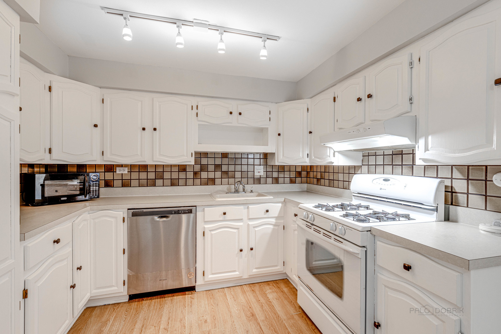 1100 Stoughton Court, Unit 1711 Schaumburg, IL 60193 - Photo 13 of 25 a kitchen with white cabinets and white appliances