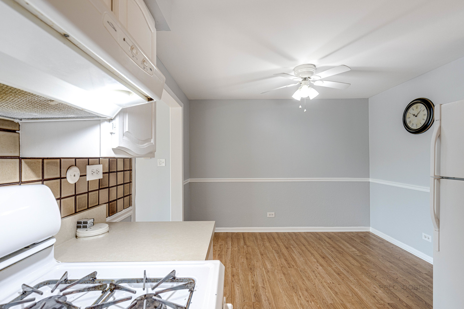 1100 Stoughton Court, Unit 1711 Schaumburg, IL 60193 - Photo 14 of 25 an empty room with wooden floor and fan