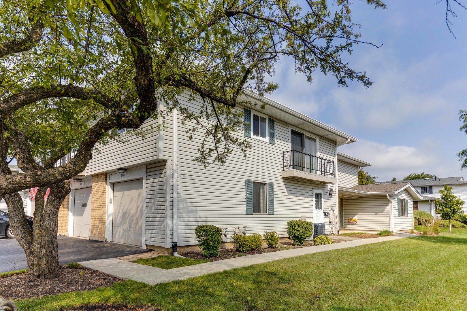 1100 Stoughton Court, Unit 1711 Schaumburg, IL 60193 - Photo 23 of 25 a front view of a house with a yard