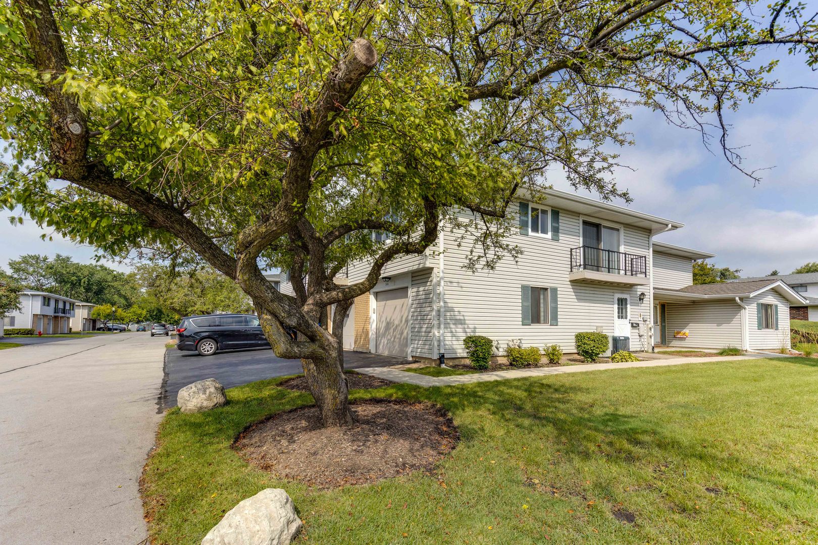 1100 Stoughton Court, Unit 1711 Schaumburg, IL 60193 - Photo 24 of 25 a front view of a house with a yard