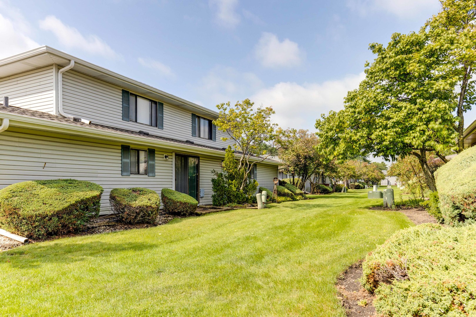 1100 Stoughton Court, Unit 1711 Schaumburg, IL 60193 - Photo 25 of 25 a front view of a house with a yard