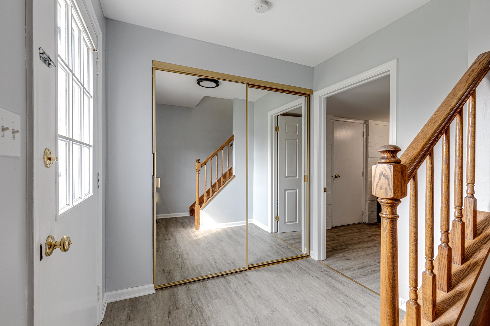 1100 Stoughton Court, Unit 1711 Schaumburg, IL 60193 - Photo 5 of 25 a view of an entryway with wooden floor and door