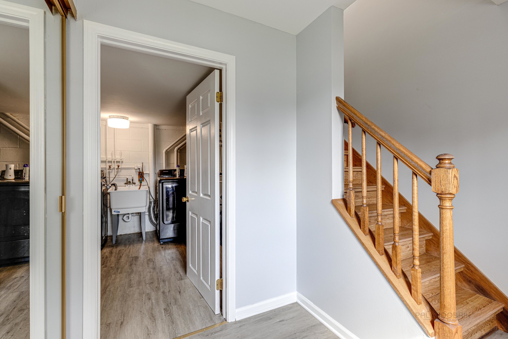 1100 Stoughton Court, Unit 1711 Schaumburg, IL 60193 - Photo 6 of 25 a view of a hallway with wooden floor and staircase