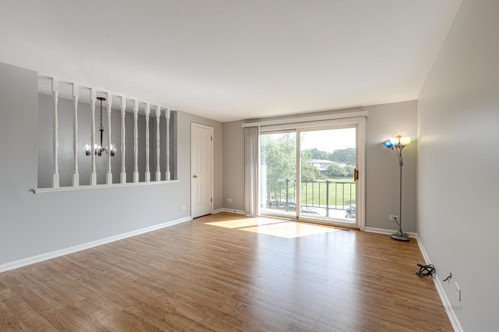 1100 Stoughton Court, Unit 1711 Schaumburg, IL 60193 - Photo 9 of 25 a view of an empty room with wooden floor and a window