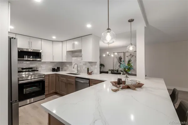 a kitchen with sink cabinets and stainless steel appliances