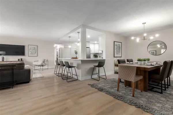 a living room with furniture a large window and a table