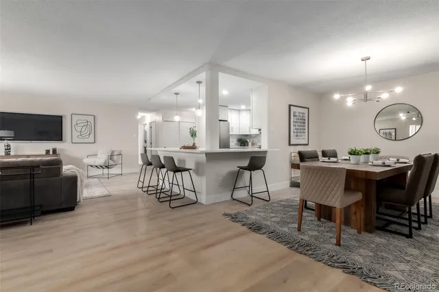 a kitchen with a table chairs refrigerator and microwave