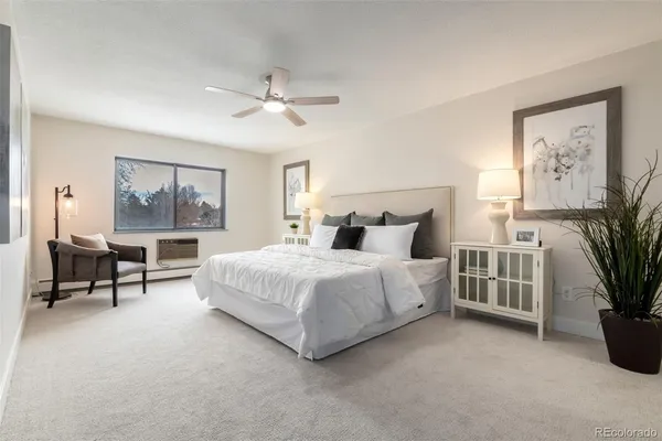 a spacious bedroom with a large bed and a painting on the wall