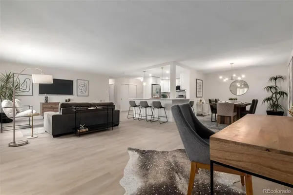 a living room with furniture kitchen view and a table