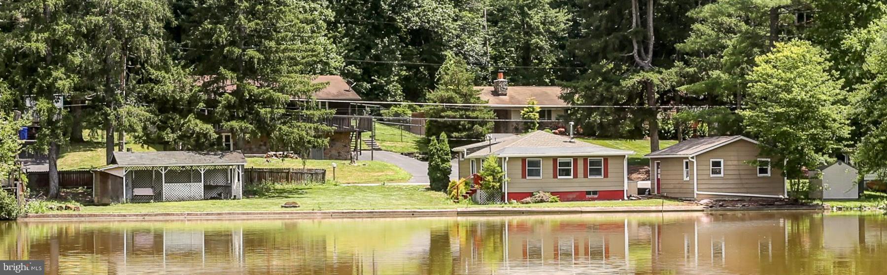 823 Silver Lake Road Lewisberry, PA 17339 - Photo 2 of 24 a front view of a house with swimming pool and porch