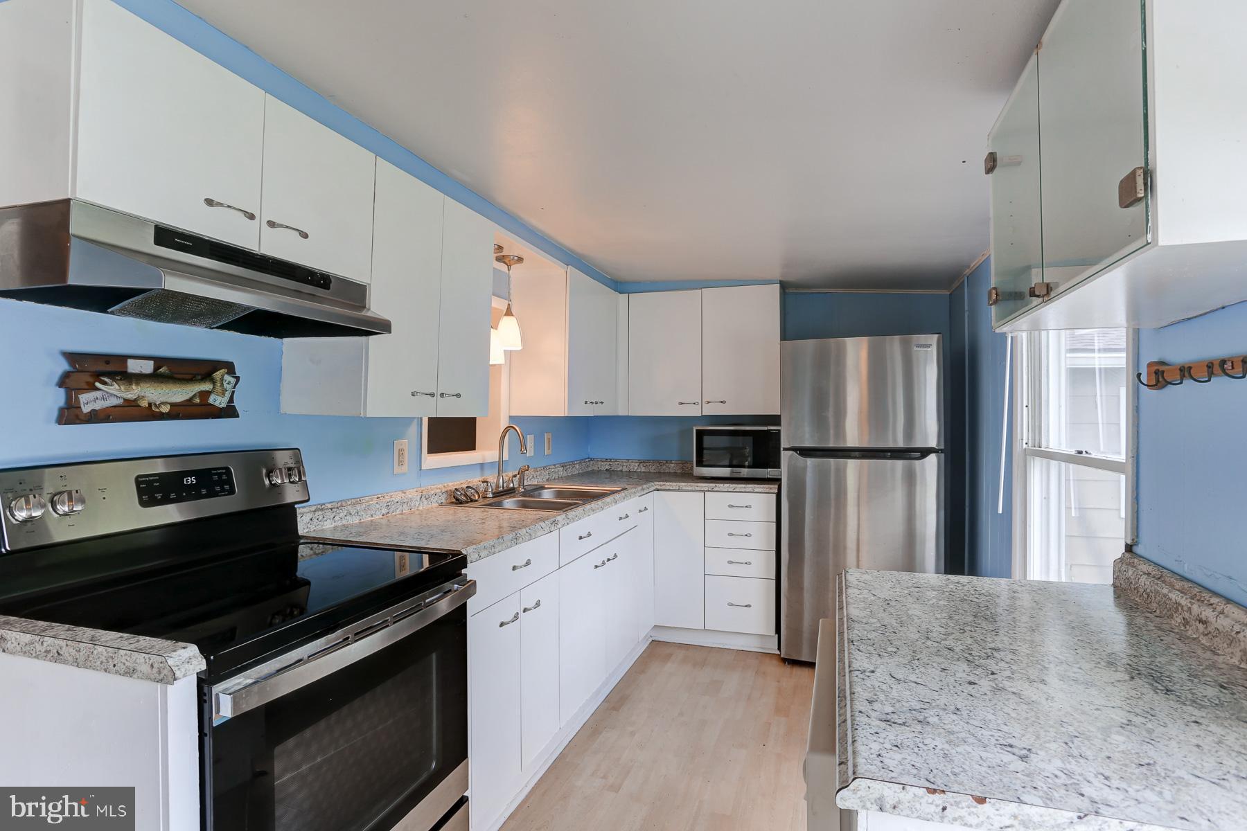 823 Silver Lake Road Lewisberry, PA 17339 - Photo 8 of 24 a kitchen with white cabinets and appliances