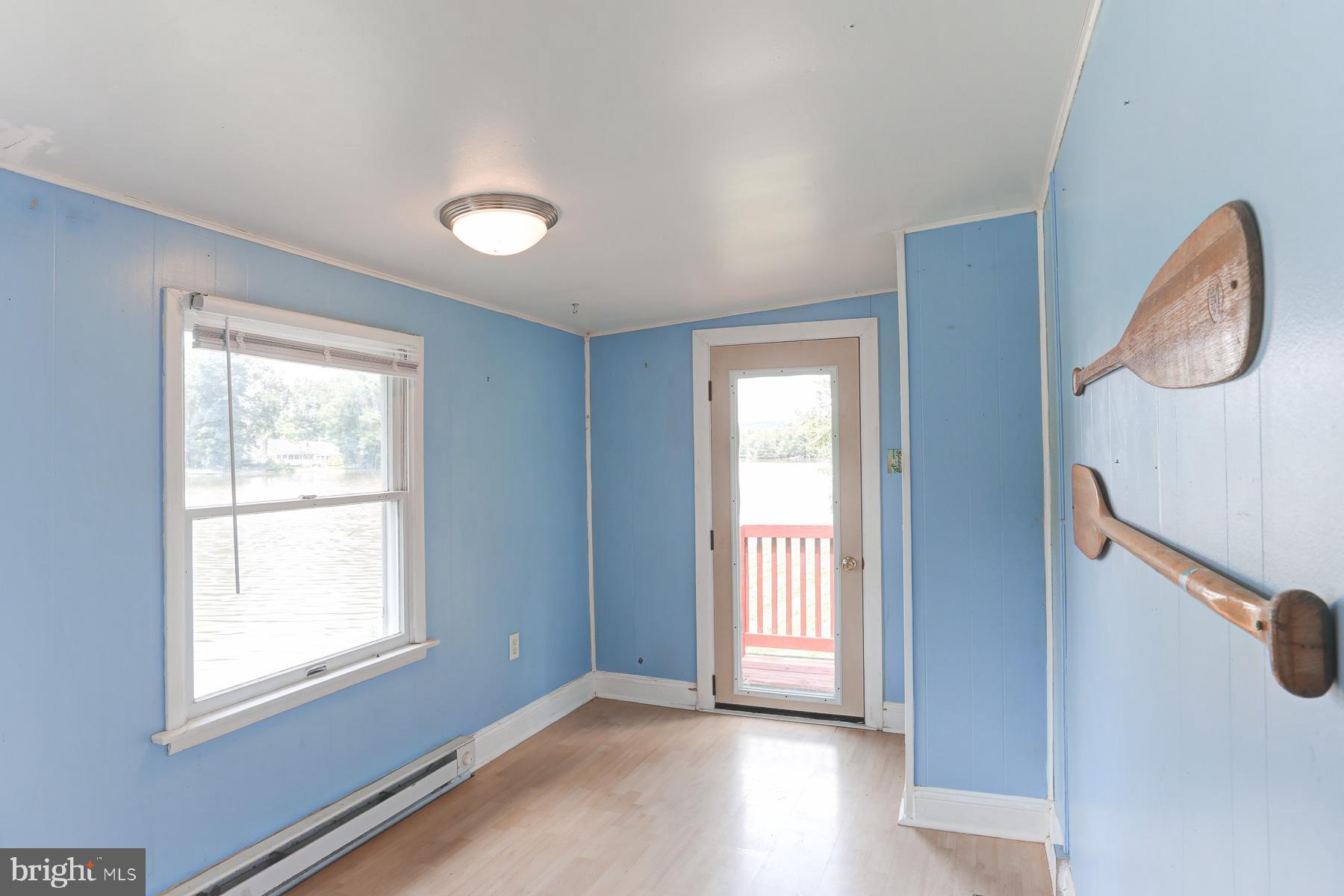 823 Silver Lake Road Lewisberry, PA 17339 - Photo 10 of 24 a view of an empty room with a window and wooden floor